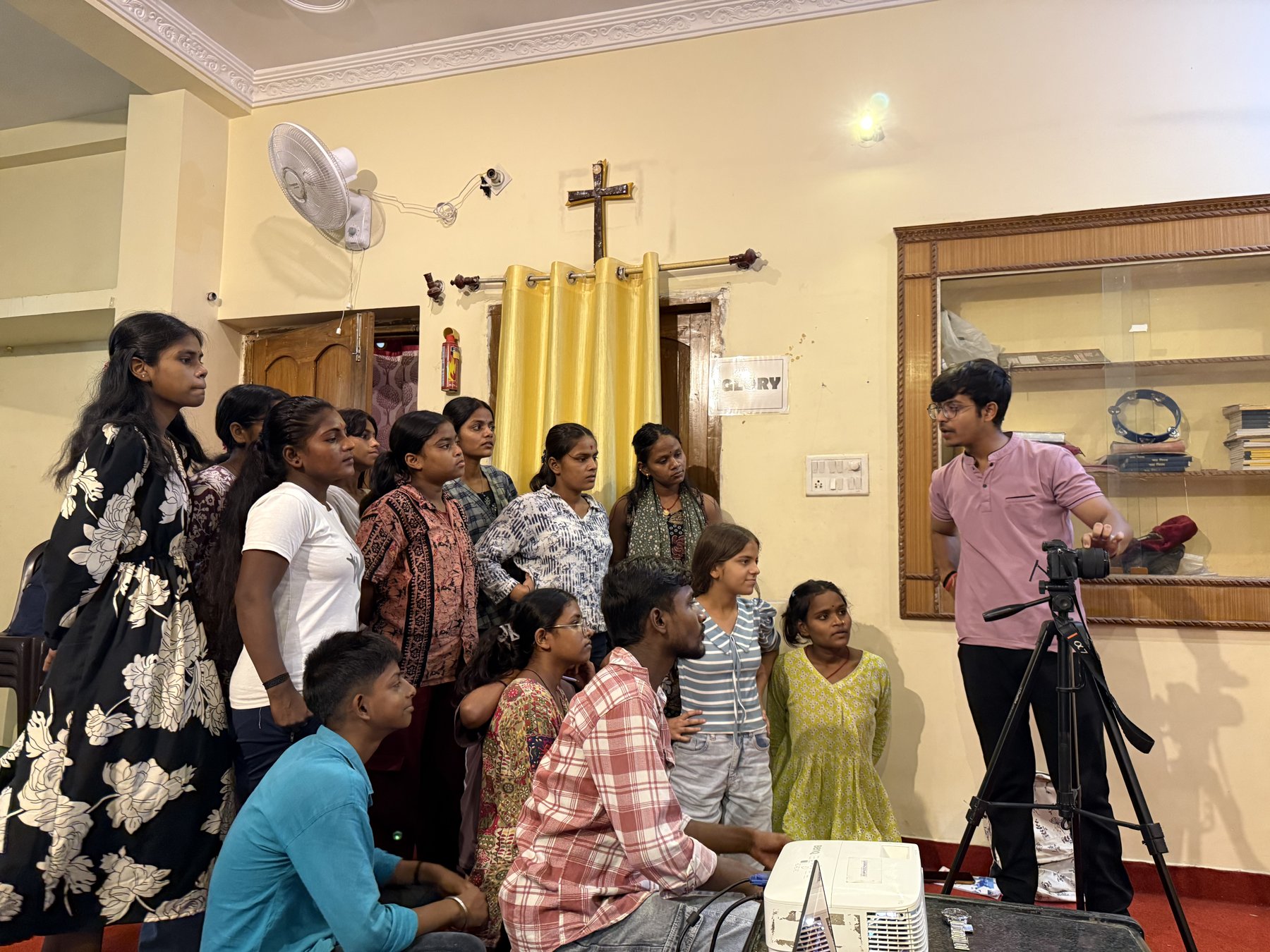 Participants gathered around a camera during the Deeksha Foundation workshop in Patna