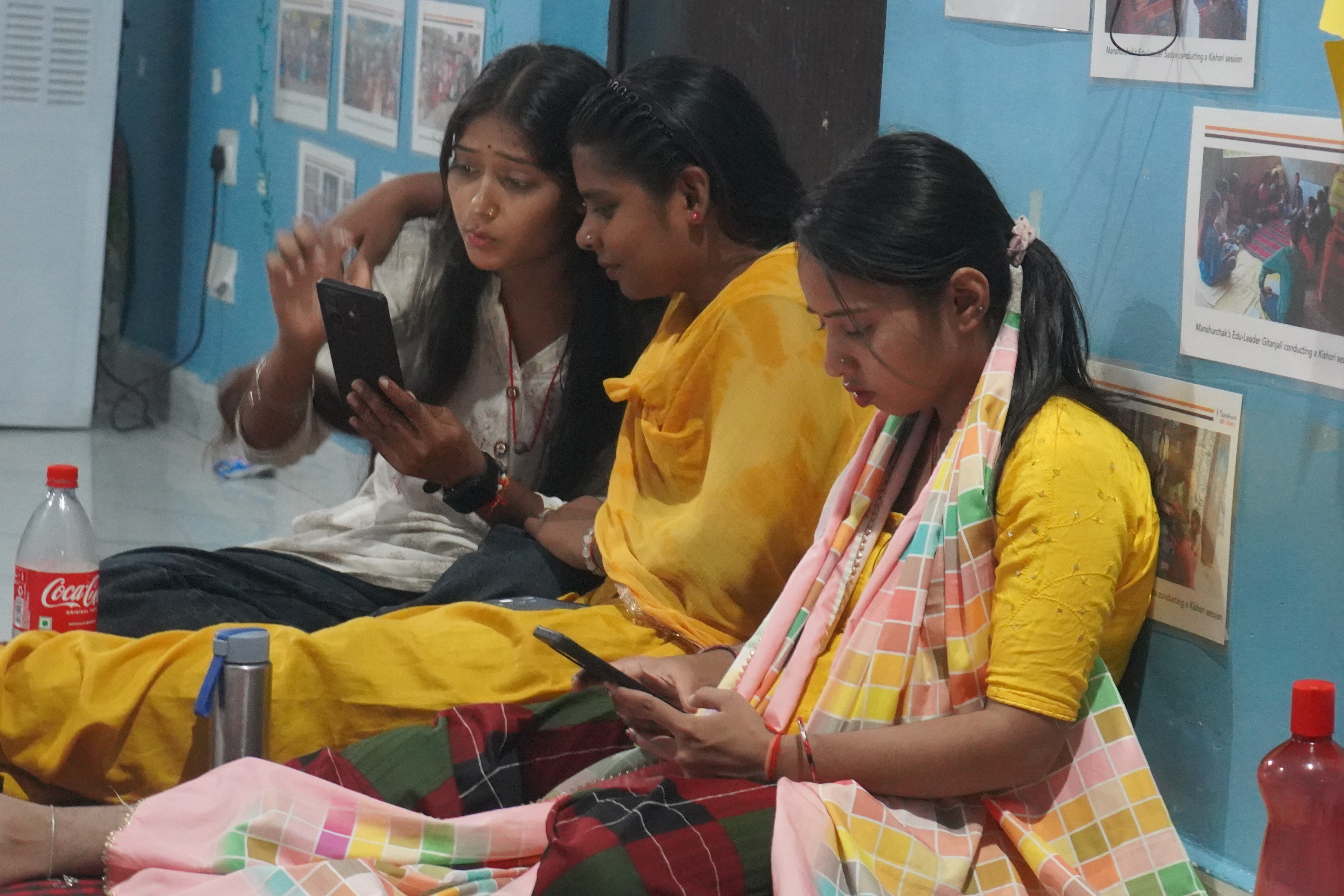 Women reviewing photographs on phones